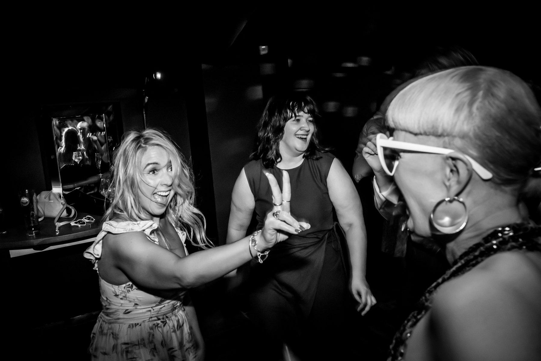 Women laughing and dancing at a party