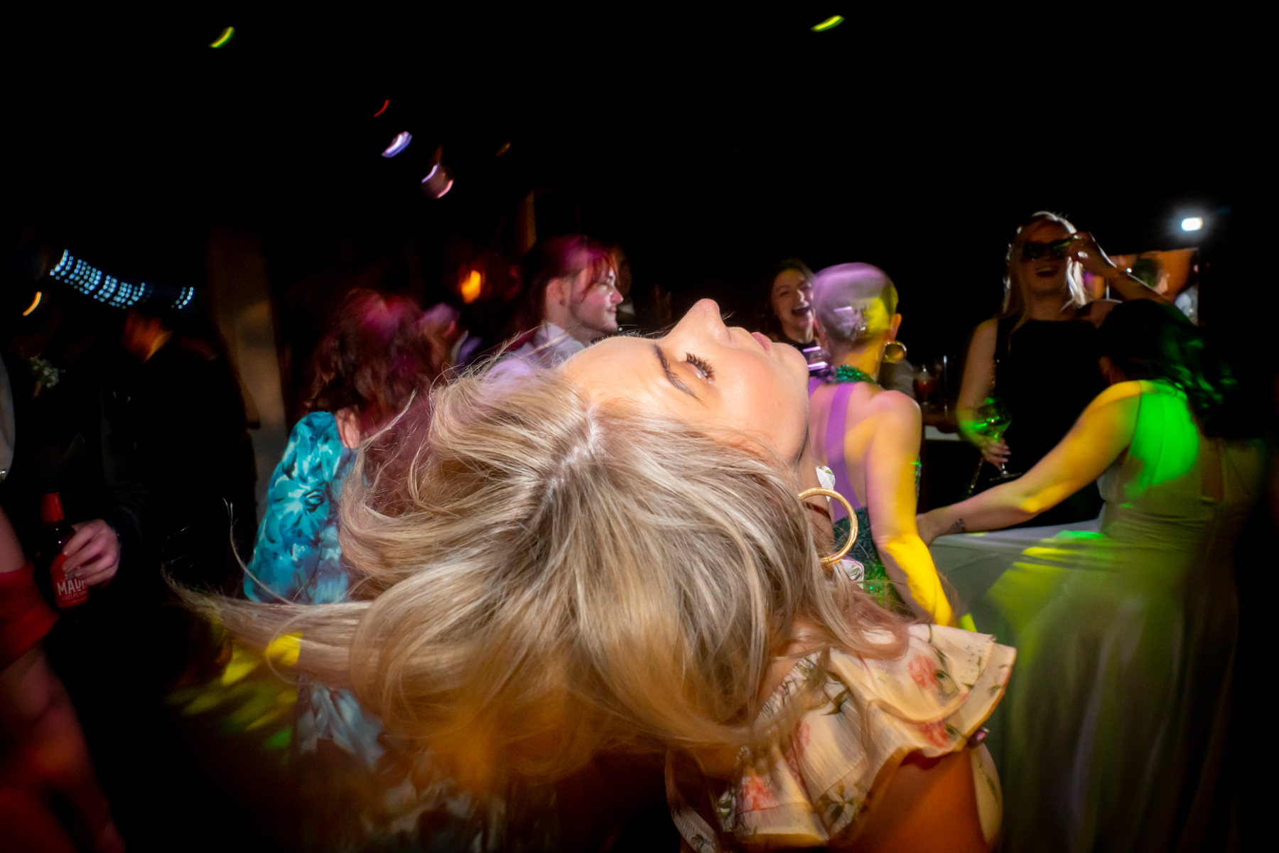 Woman flipping hair on nightclub dance floor