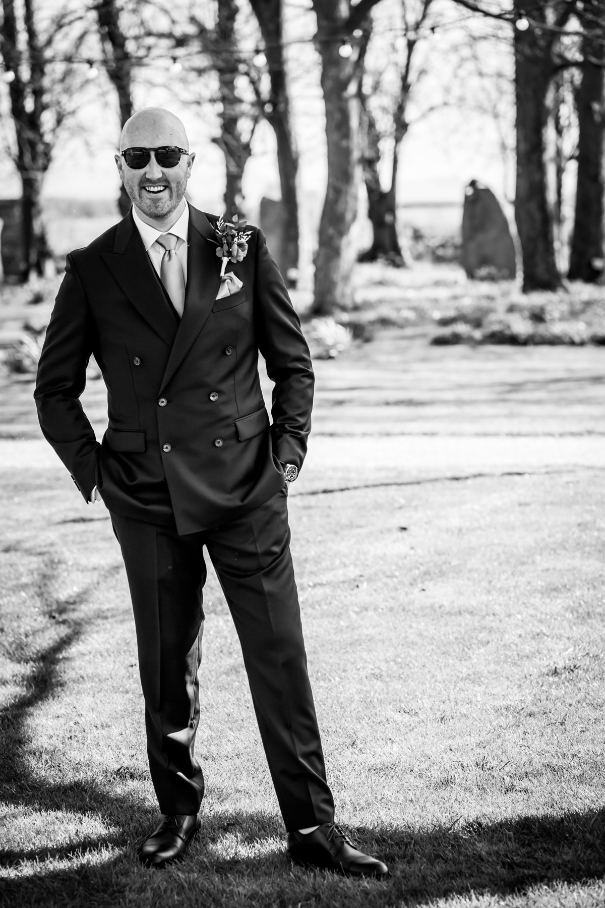 Black-and-white portrait of suited man outdoors