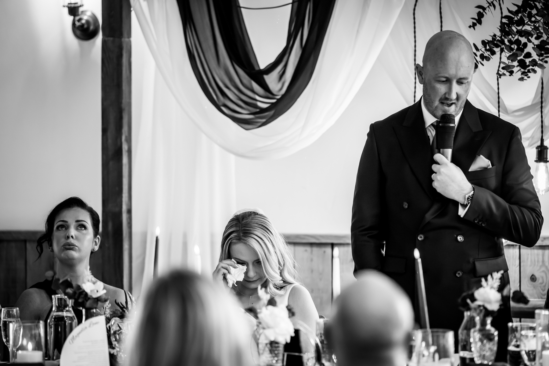 Groom giving emotional speech at wedding reception