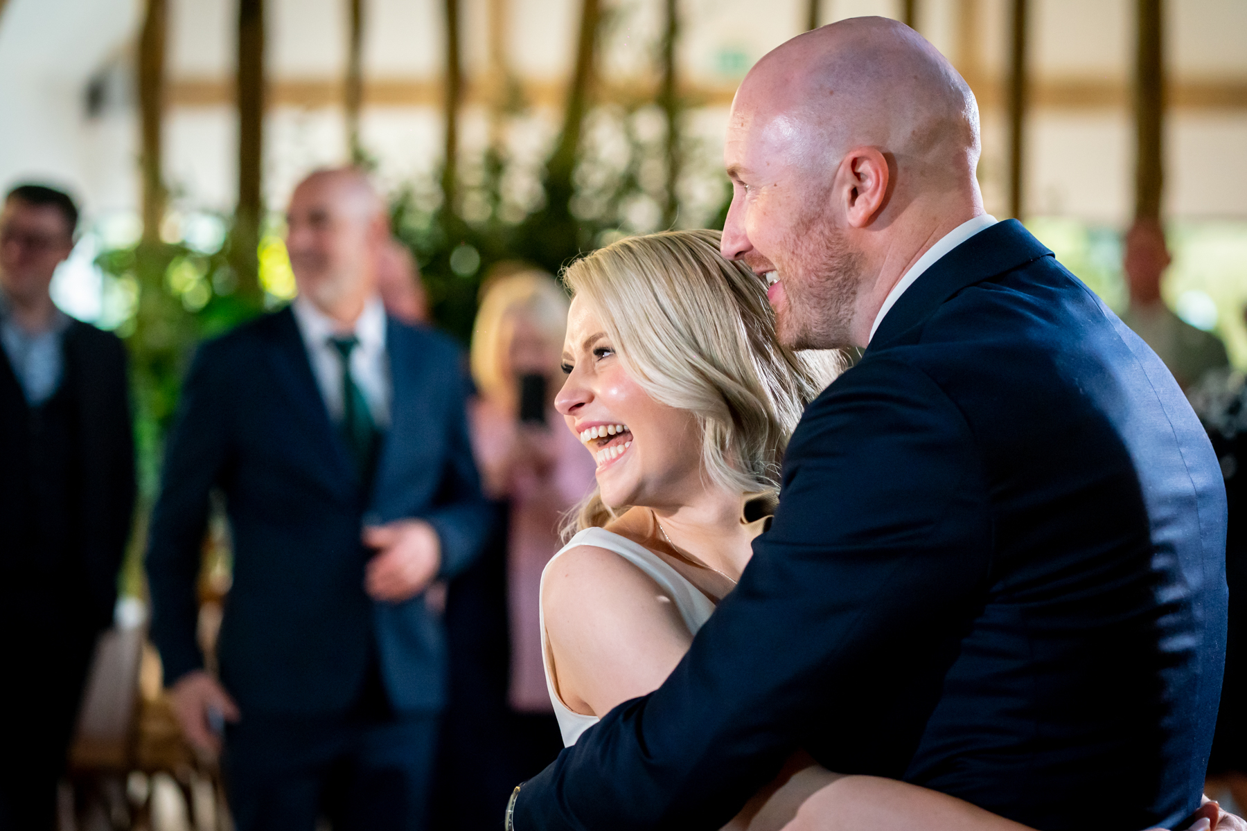 Couple embracing and laughing at wedding reception