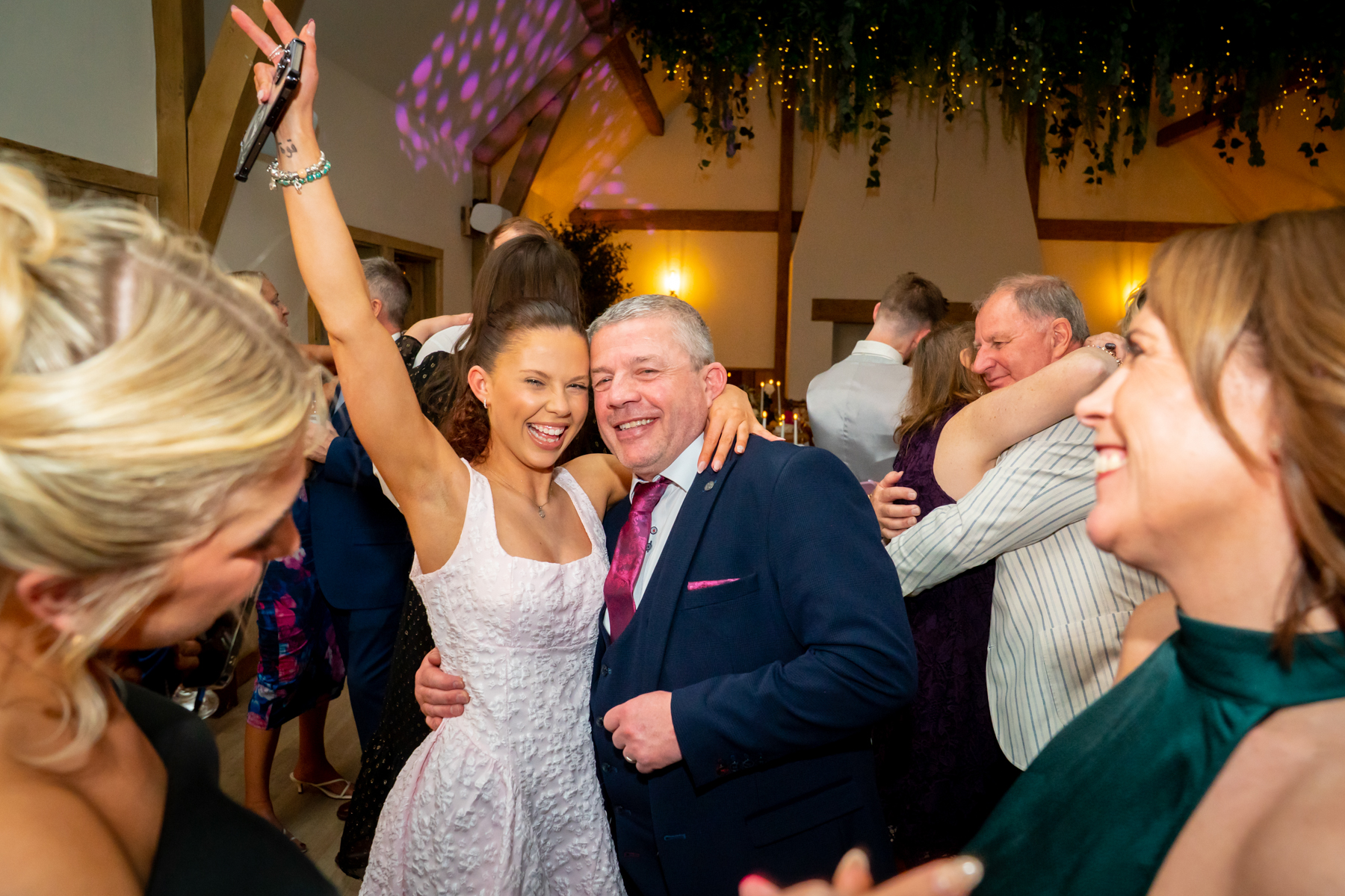 Bride dancing and taking selfie at wedding reception
